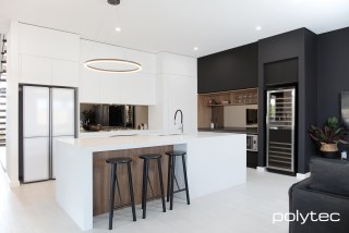 Polytec - Shelving and bar panels in Notaio Walnut Ravine, Overhead cupboards in Black Venette, Doors, drawers and panels in Ultra White Venette.